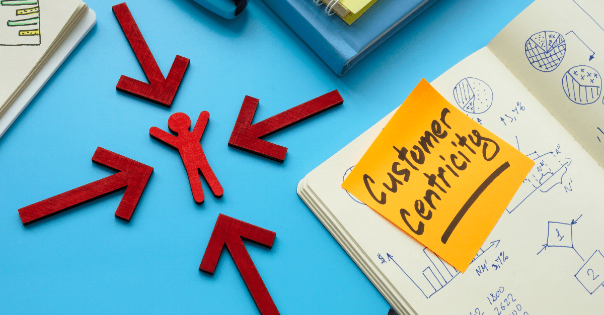 Blog cover picture of customer being in the center of 4 arrows with a post it reading 'customer centricity'